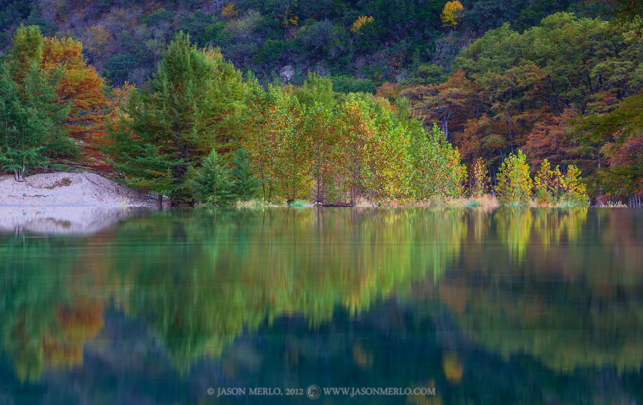 Sycamore and cypress trees are reflected in the Frio River near dusk&nbsp;at Garner State Park in Uvalde County in the Texas...