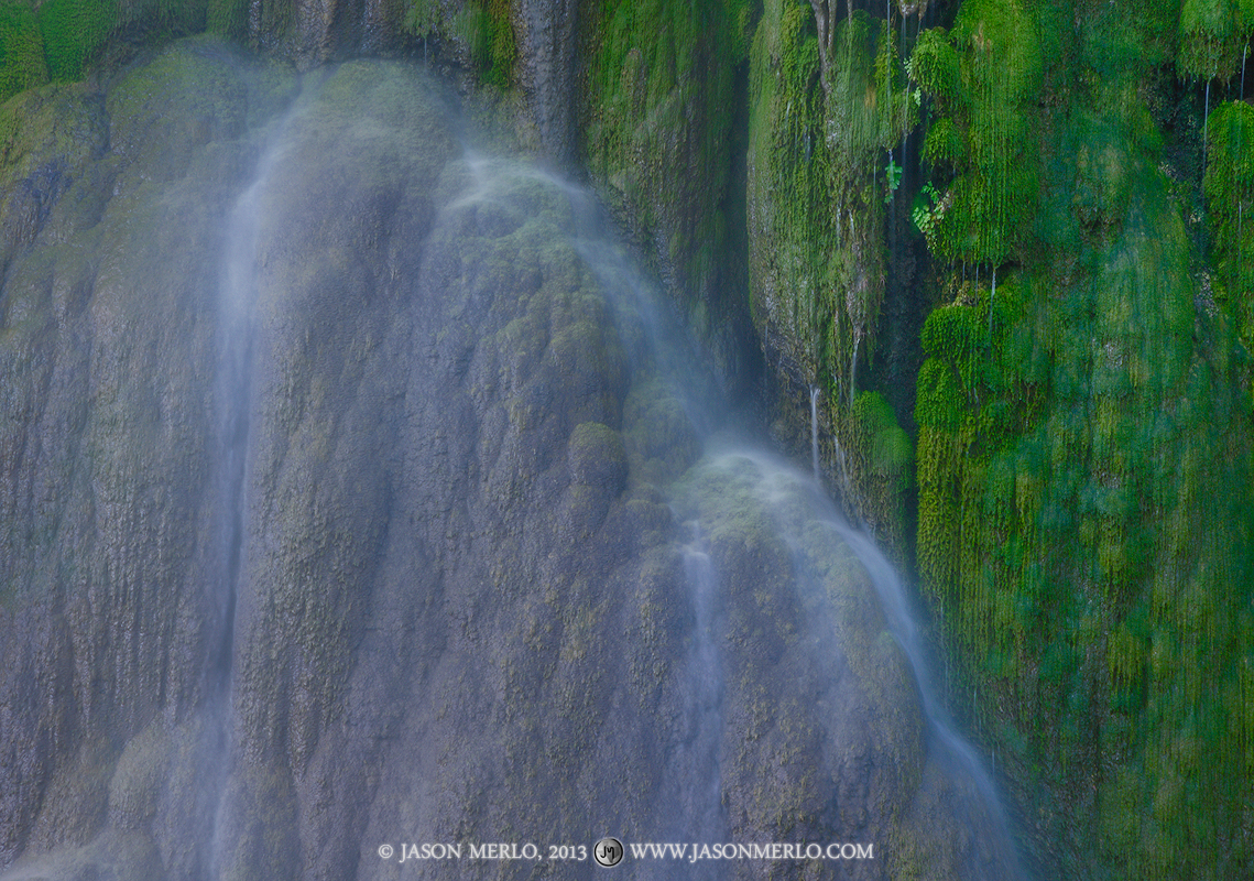 Water falling over moss covered travertine formations at Gorman Falls at Colorado Bend State Park in San Saba County in the&nbsp...