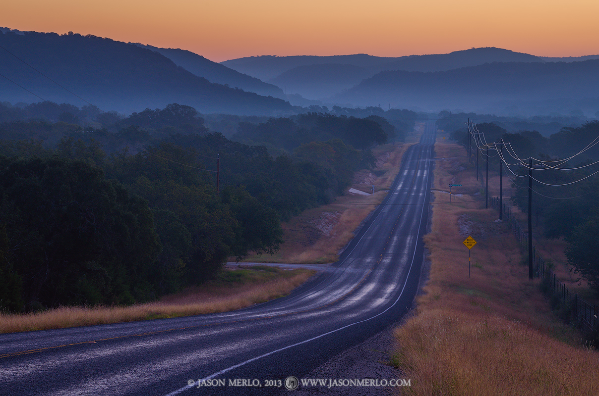 A layer of fog over Ranch Road 337 and surrounding hills at dawn in Real County in the&nbsp;Texas Hill Country.