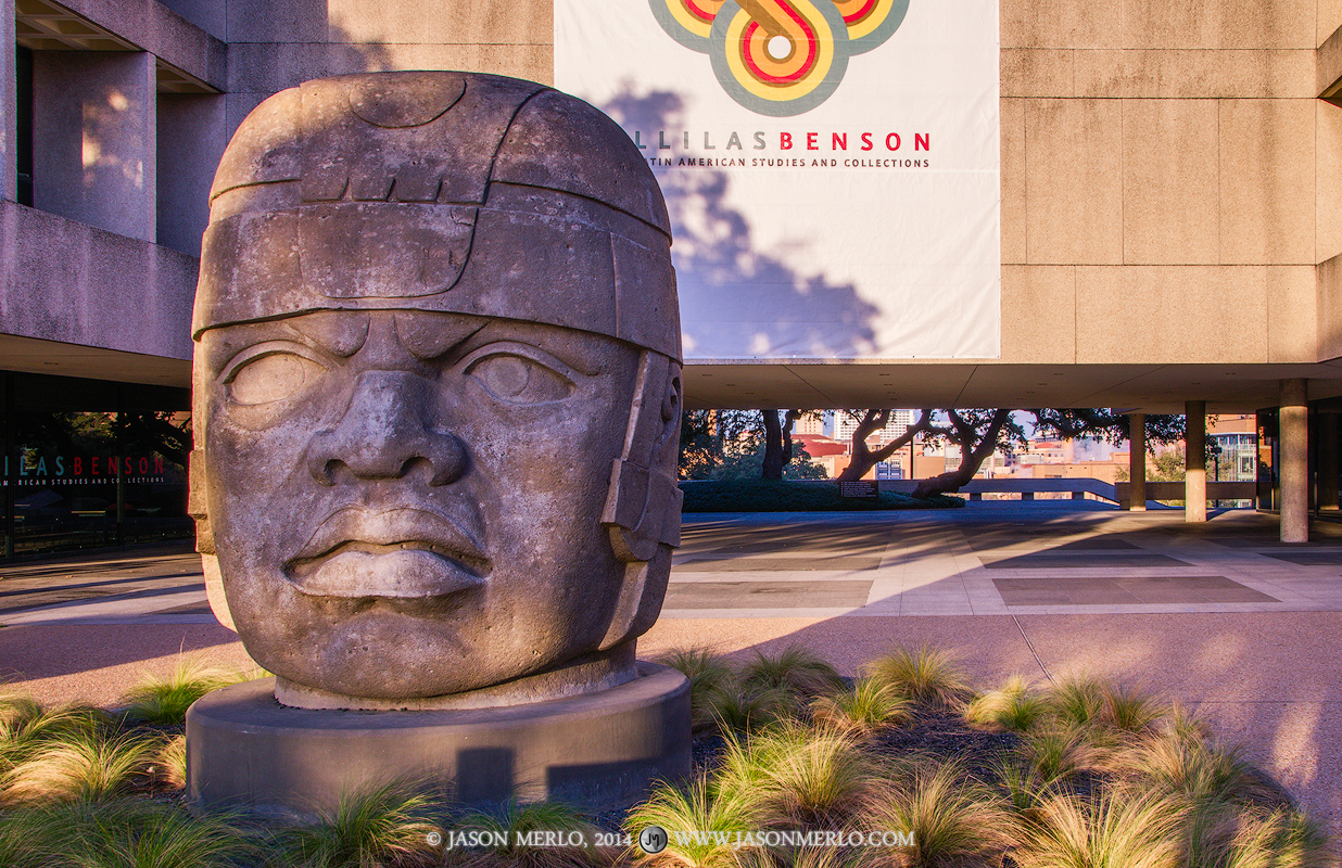 A replica colossal Olmec head catches the first morning light outside Sid Richardson Hall on the campus of the University of...