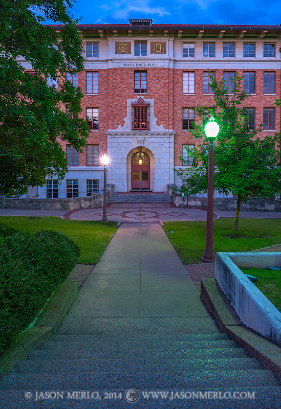 Waggener Hall at dusk on the campus of the University of Texas in Austin, Texas.