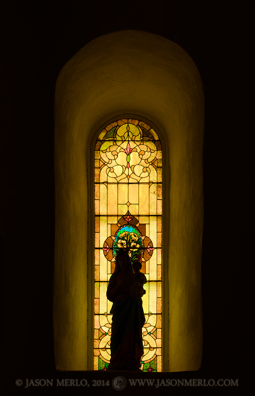 Silhouette of a statue of the Virgin Mary in front of a stained glass window at San Elizario Presidio Chapel in San Elizario (...