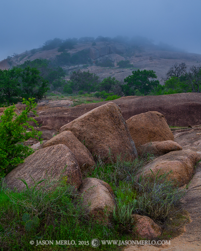 Freshman Mountain under a layer of fog at Enchanted Rock State Natural Area in Llano County in the Texas Hill Country.