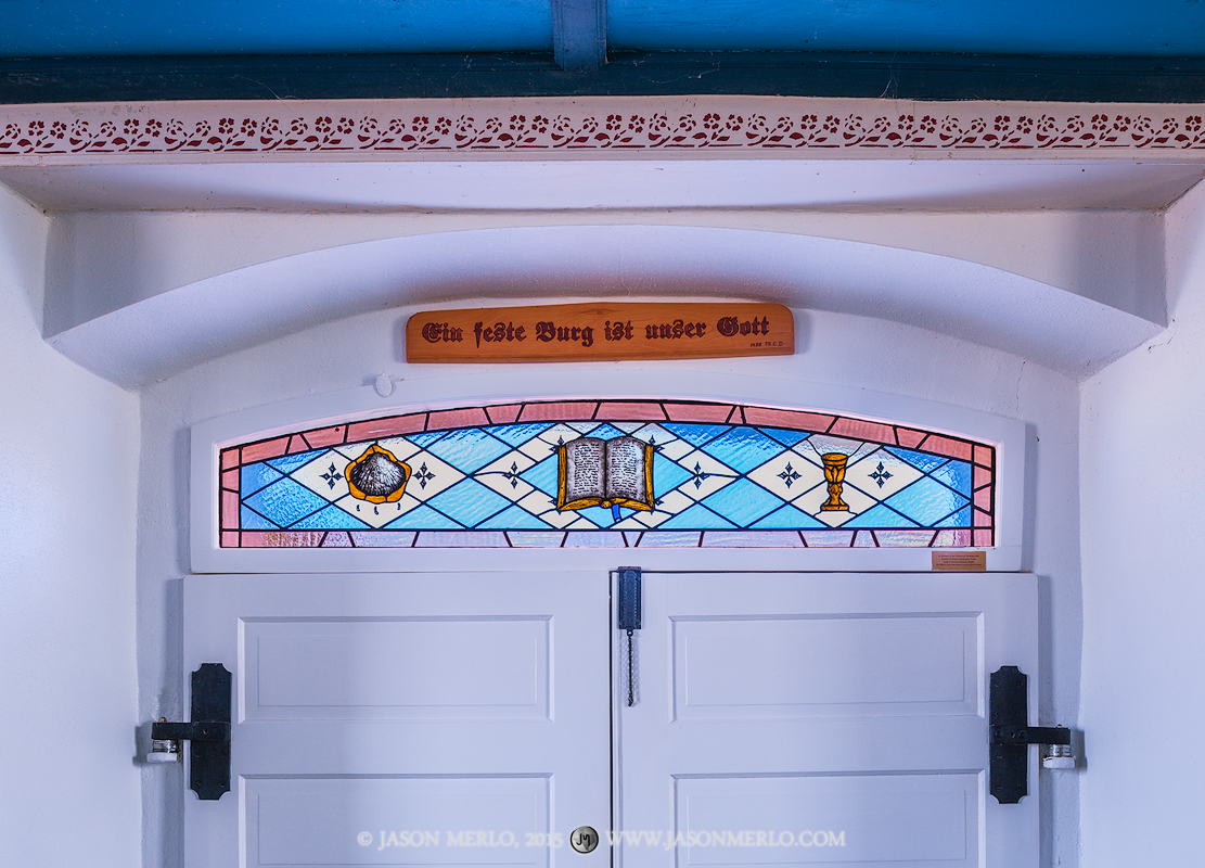 A stained glass window over the chapel doors at St. Paul Lutheran Church in Serbin, one of the Painted Churches of Texas. The...