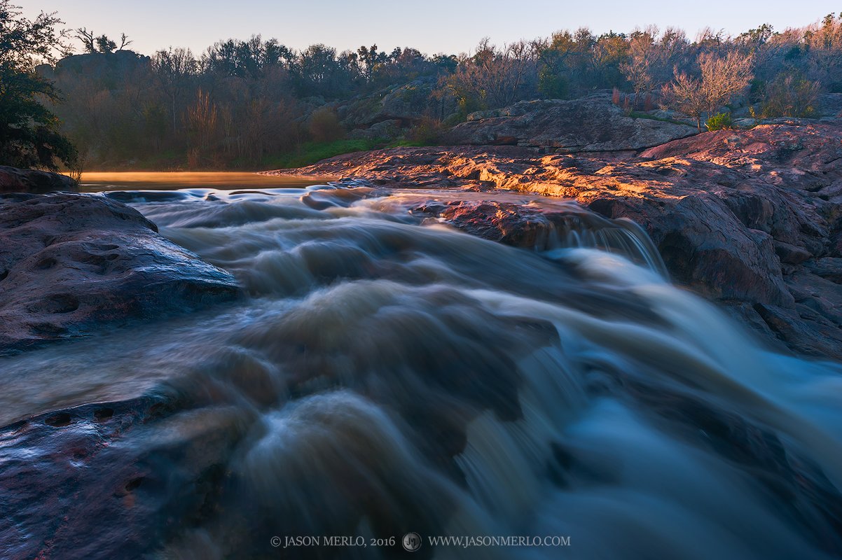 A waterfall on Spring Creek flows strongly after recent rains at Inks Lake State Park in Burnet County in the Llano Uplift of...