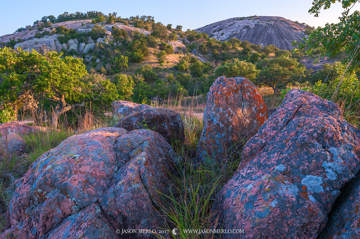 Lichen covered boulders beneath Freshman Mountain and Enchanted Rock at Enchanted Rock State Natural Area in Llano County in...