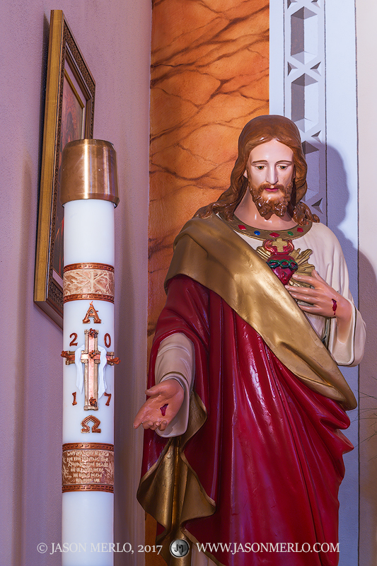 A candle and statue of Jesus at St. Ann's Catholic Church in Kosciusko, one of the Painted Churches of Texas.