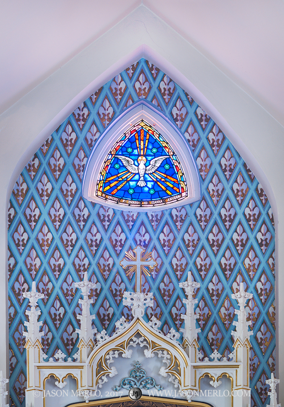 The painted apse and a stained glass window at Immaculate Conception of the Blessed Virgin Mary Catholic Church in Panna Maria...