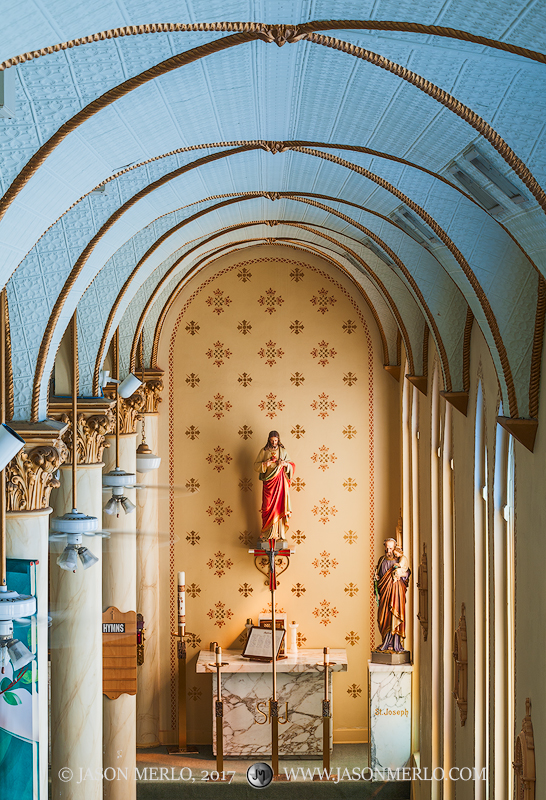 Arches and the side altar at Our Lady of Grace Catholic Church in La Coste, one of the Painted Churches of Texas.