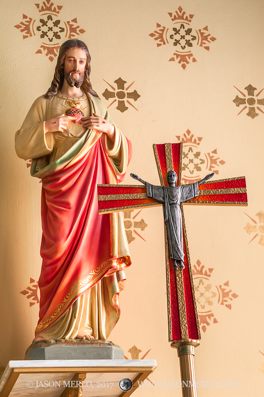 A crucifix and statue of Jesus at Our Lady of Grace Catholic Church in La Coste, one of the Painted Churches of Texas.