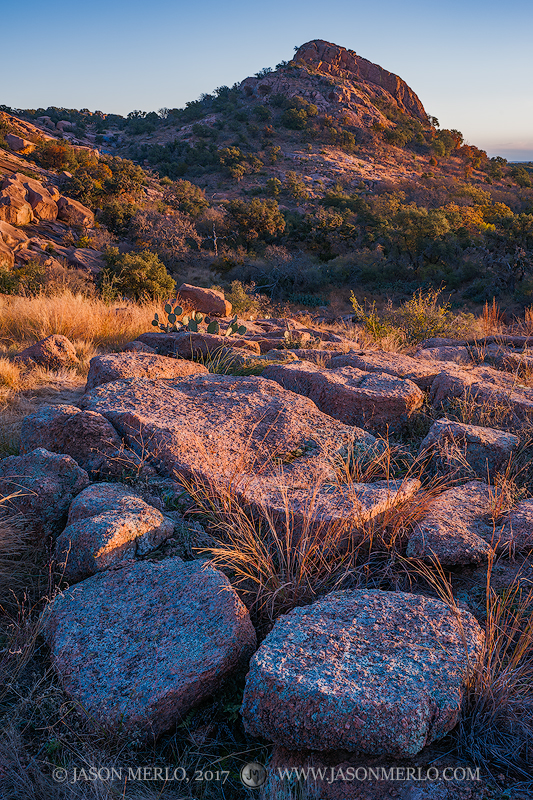 First light on granite boulders beneath Turkey Peak at Enchanted Rock State Natural Area in Llano County in the Texas Hill Country...