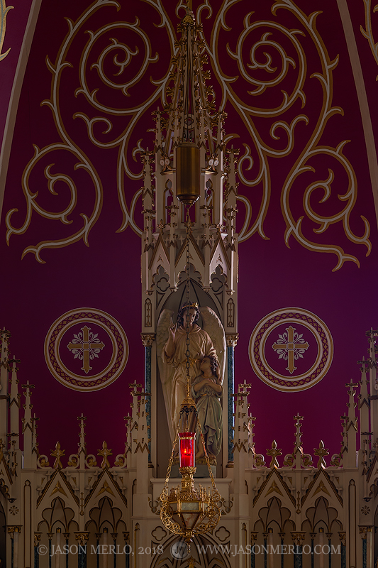 A candle burning in front of the altar at Guardian Angel Catholic Church in Wallis, one of the Painted Churches of Texas.