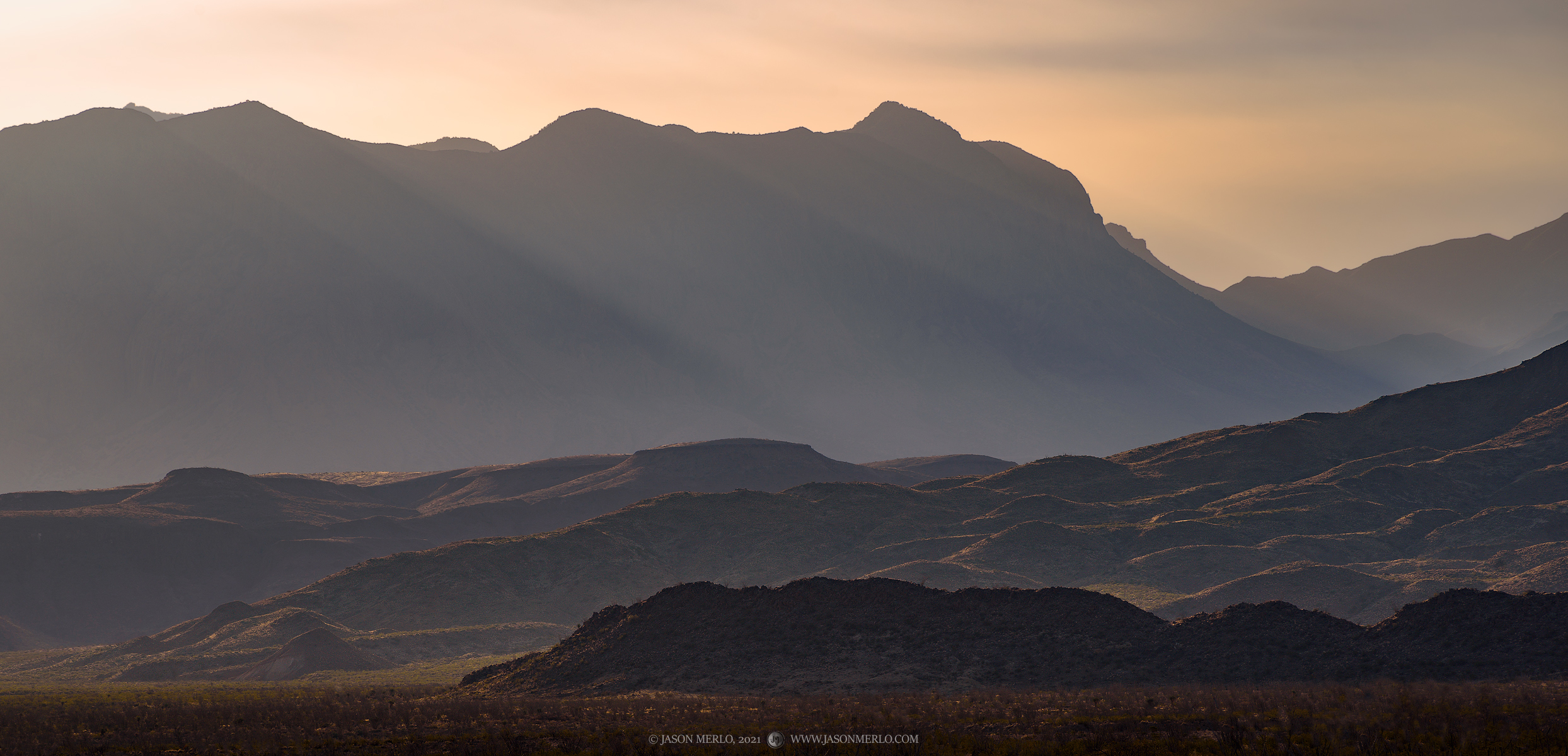 Mid-morning sunlight shining over the Chisos Mountains in Big Bend National Park in Brewster County in West Texas.