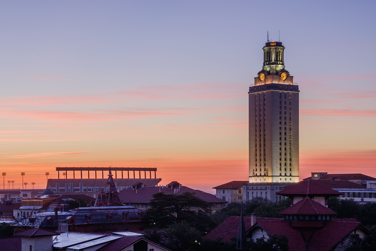 The sun casts color on clouds over the campus of the Univerisity of Texas in Austin, Texas just before sunrise. The Tower and...